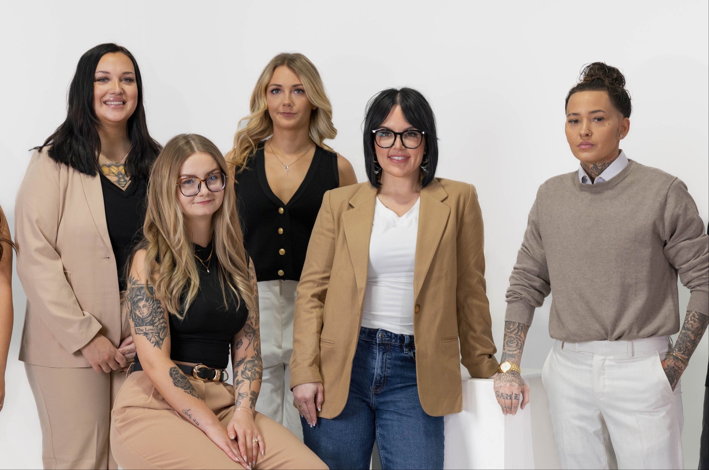 Group of seven women who work at Weekday Ritual posing together against a white background