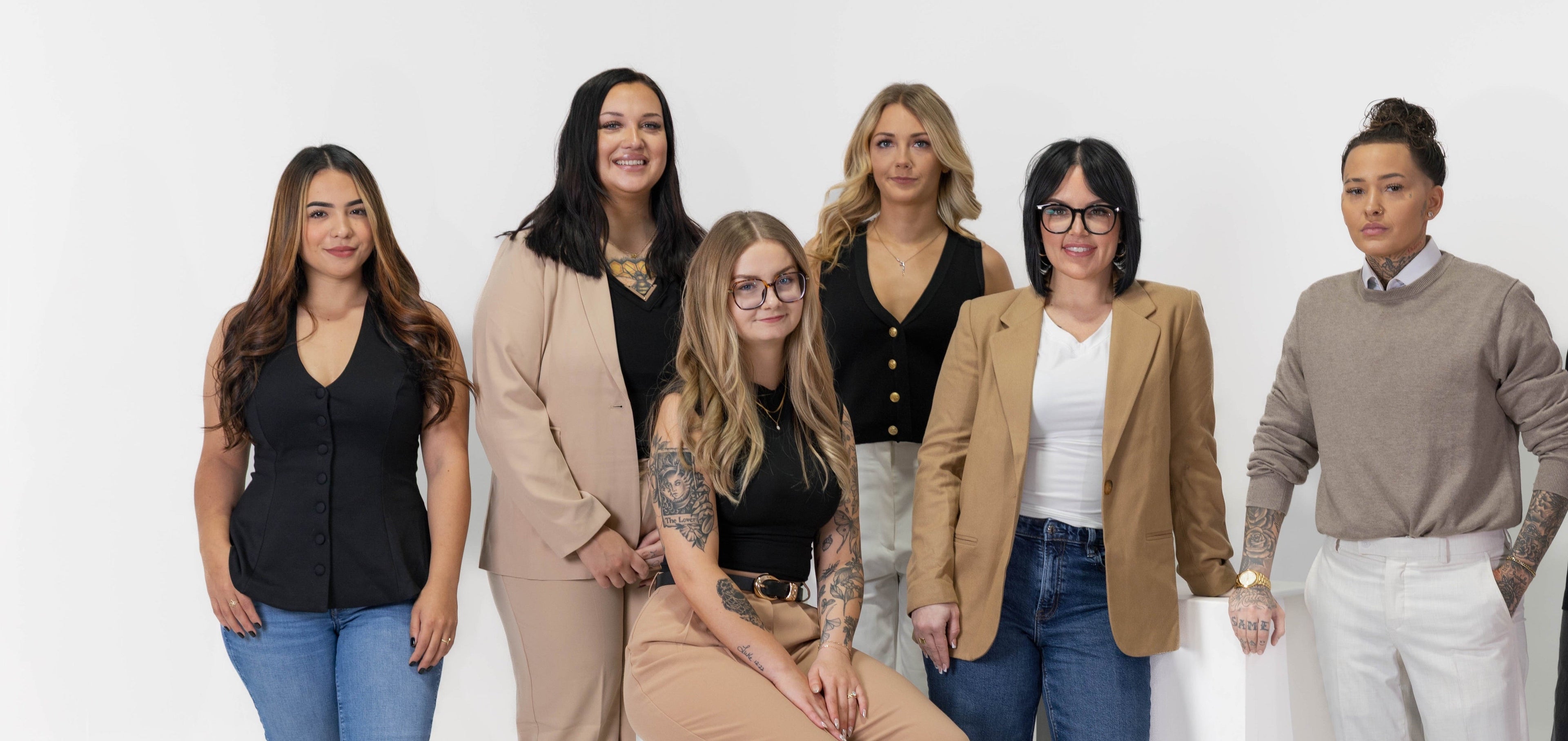 Group of seven women who work at Weekday Ritual posing together against a white background