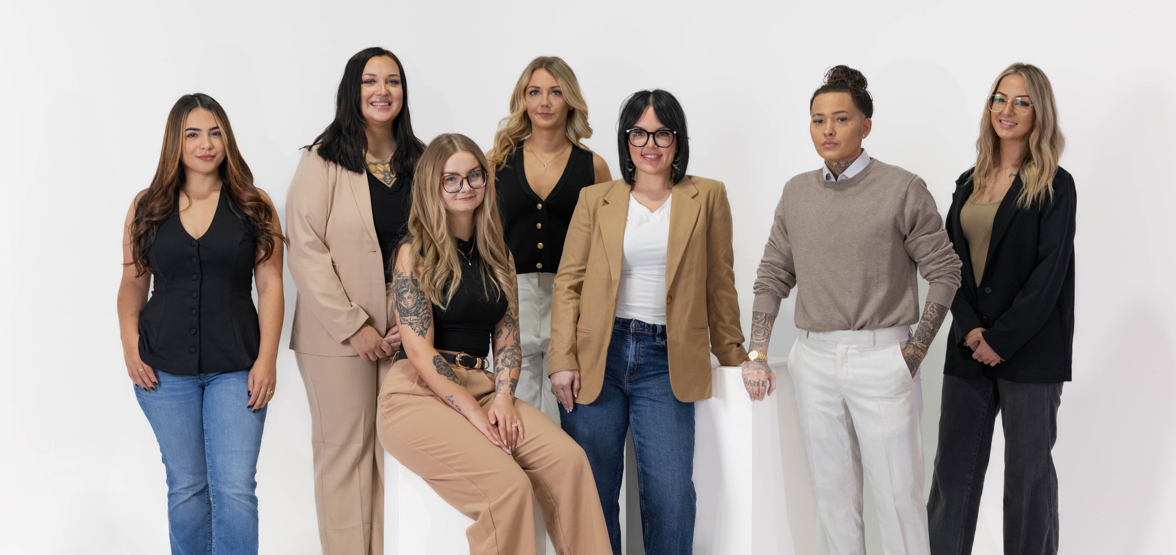 Group of seven women who work at Weekday Ritual posing together against a white background